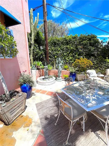 a view of a patio with couches and potted plants
