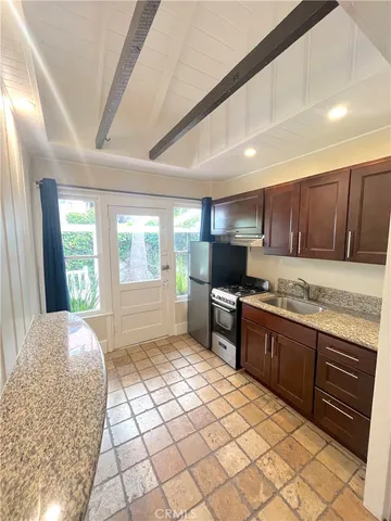 a kitchen with stainless steel appliances granite countertop a sink stove and cabinets