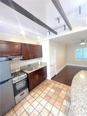 a kitchen with a stove a sink and a refrigerator