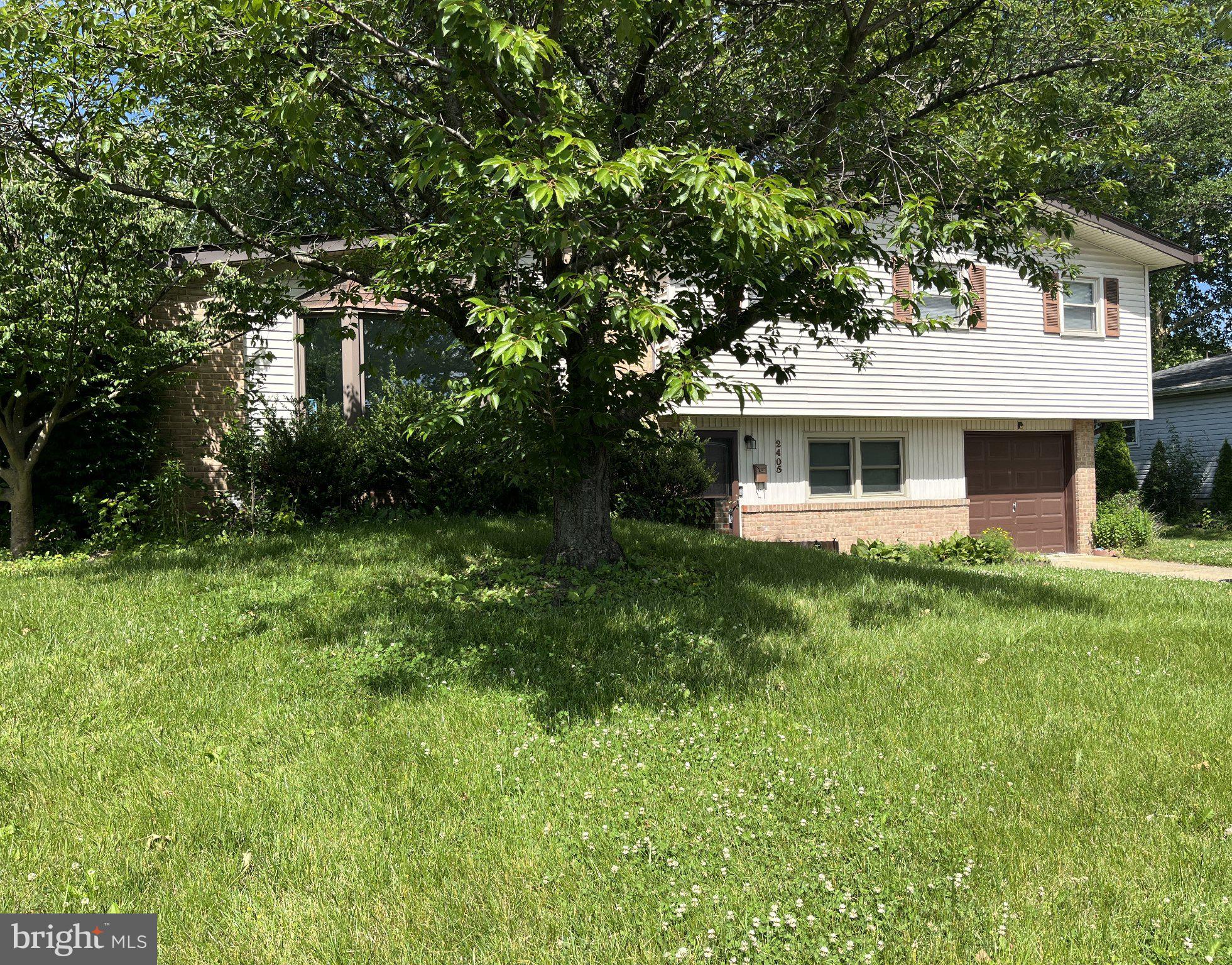 2405 Limestone Road Wilmington, DE 19808 - Photo 4 of 40 a front view of a house with a yard and trees