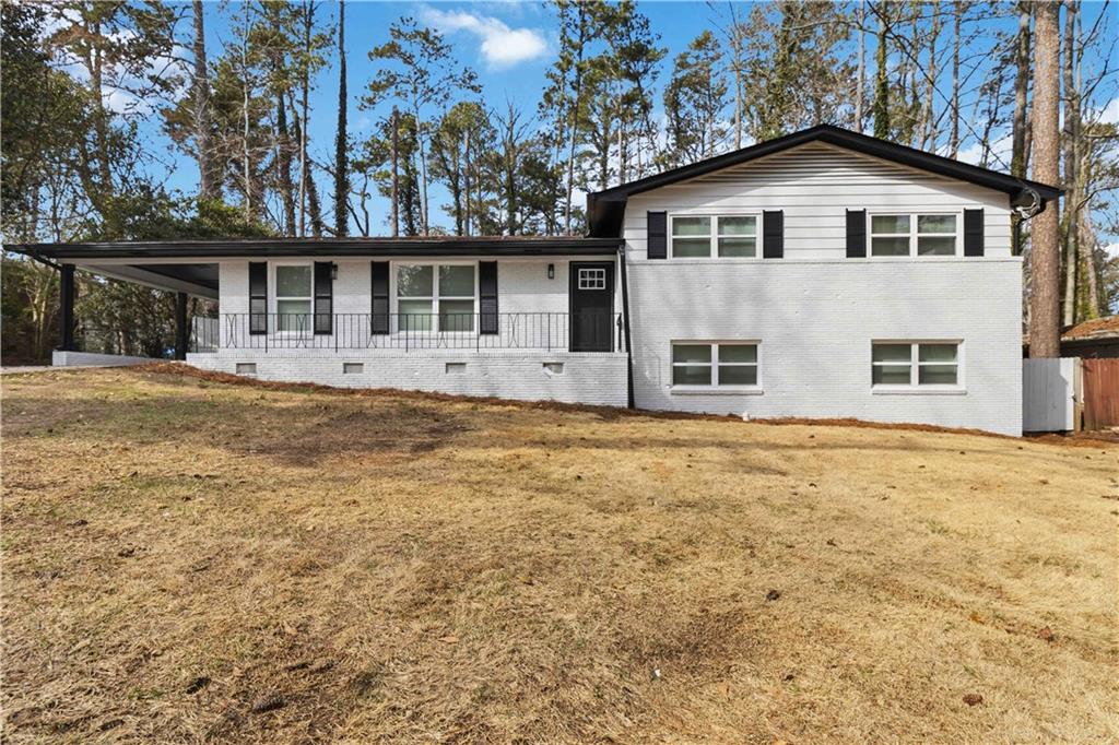 2275 Country Club Lane Southwest Atlanta, GA 30311 - Photo 1 of 32 a front view of a house with a garden