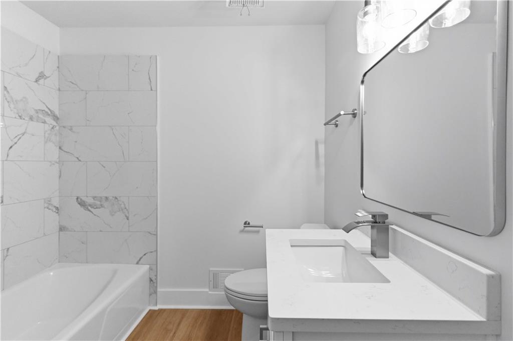 2275 Country Club Lane Southwest Atlanta, GA 30311 - Photo 13 of 32 a bathroom with a sink a toilet and bathtub