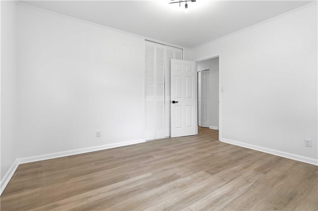 2275 Country Club Lane Southwest Atlanta, GA 30311 - Photo 15 of 32 a view of an empty room with wooden floor