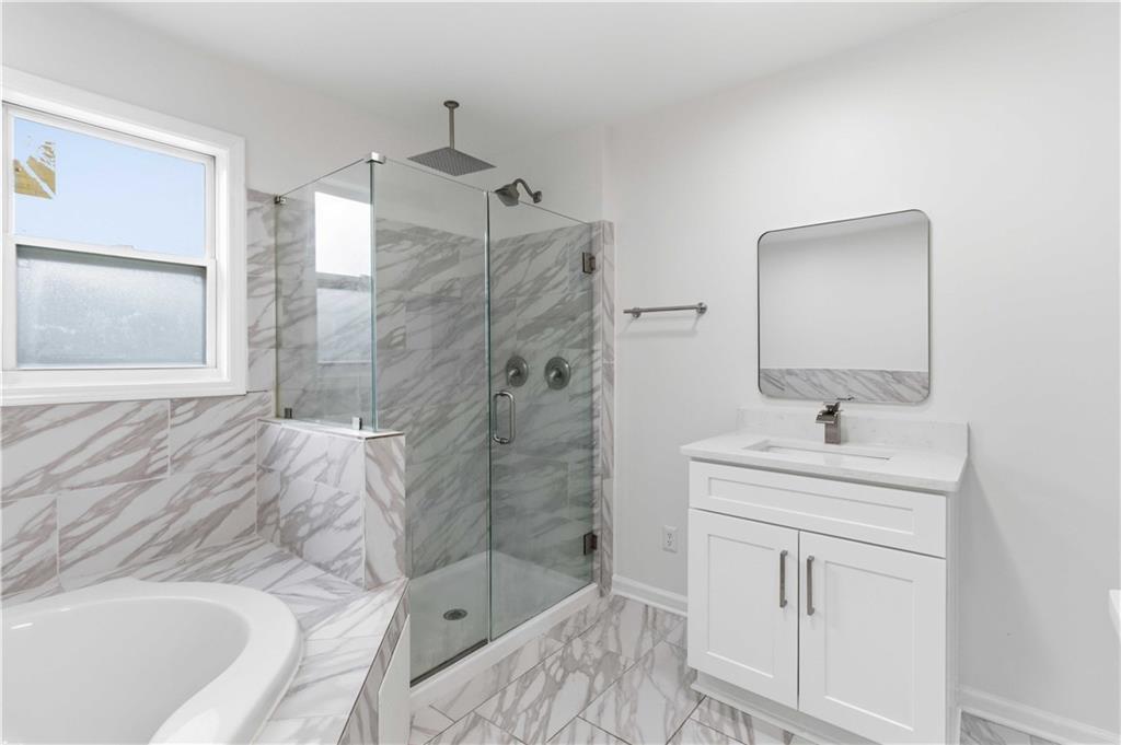 2275 Country Club Lane Southwest Atlanta, GA 30311 - Photo 18 of 32 a bathroom with a sink a toilet and shower