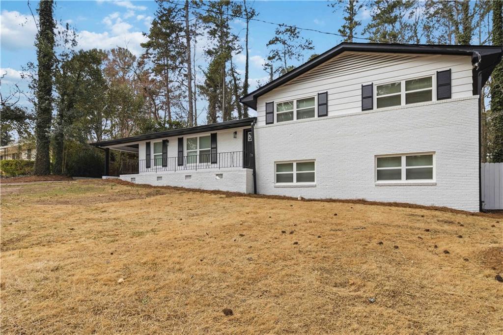 2275 Country Club Lane Southwest Atlanta, GA 30311 - Photo 2 of 32 a house with trees in the background