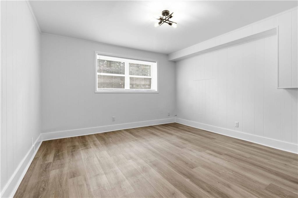 2275 Country Club Lane Southwest Atlanta, GA 30311 - Photo 21 of 32 wooden floor in an empty room with a window
