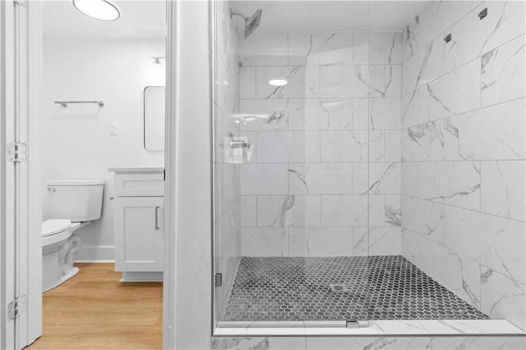 2275 Country Club Lane Southwest Atlanta, GA 30311 - Photo 23 of 32 a bathroom with a glass door shower