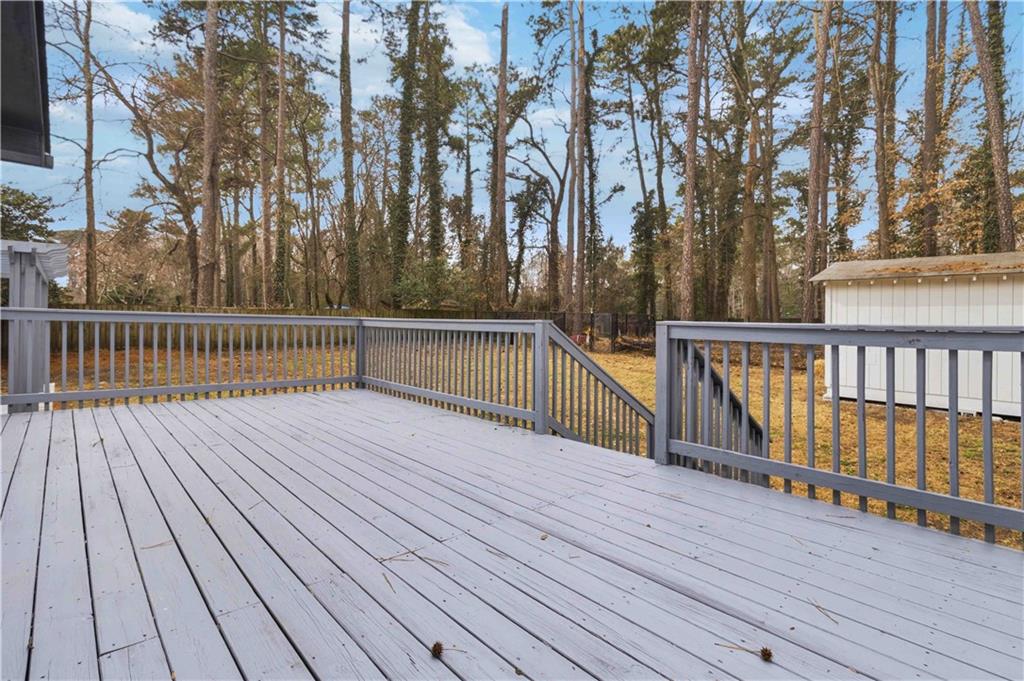 2275 Country Club Lane Southwest Atlanta, GA 30311 - Photo 25 of 32 a view of deck with wooden floor and fence with large trees