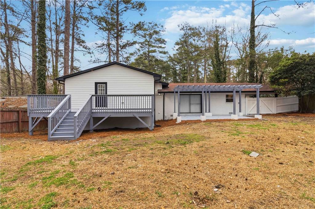 2275 Country Club Lane Southwest Atlanta, GA 30311 - Photo 28 of 32 a view of a house with a patio and a yard