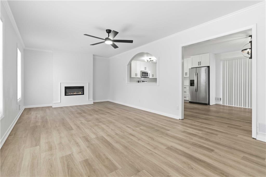2275 Country Club Lane Southwest Atlanta, GA 30311 - Photo 6 of 32 a view of empty room with wooden floor and fan