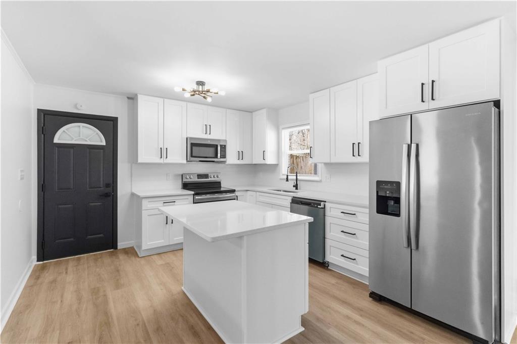 2275 Country Club Lane Southwest Atlanta, GA 30311 - Photo 9 of 32 a kitchen with stainless steel appliances a refrigerator stove microwave and sink