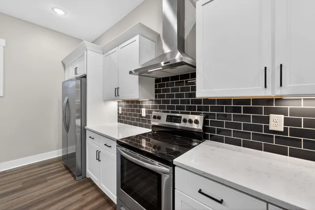 a kitchen with a stove and a refrigerator