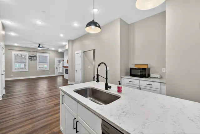 a kitchen with a sink a stove and cabinets