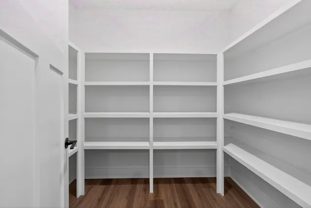 a view of walk in closet with empty racks