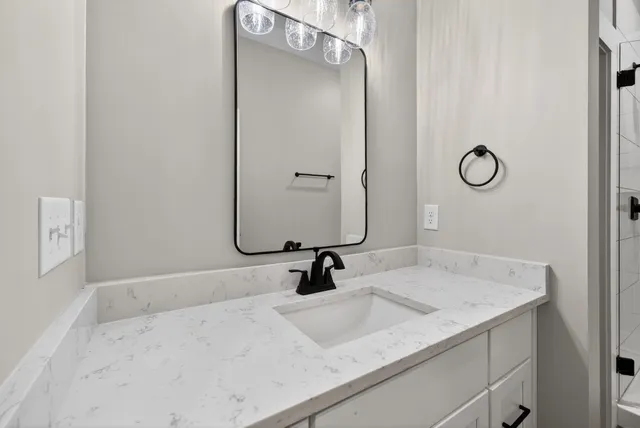 a bathroom with a sink vanity and a mirror