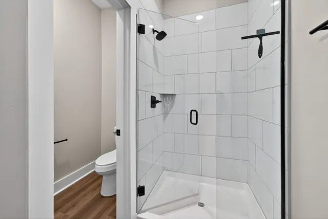 a bathroom with a toilet and a shower