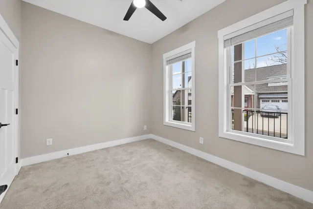 an empty room with windows and closet