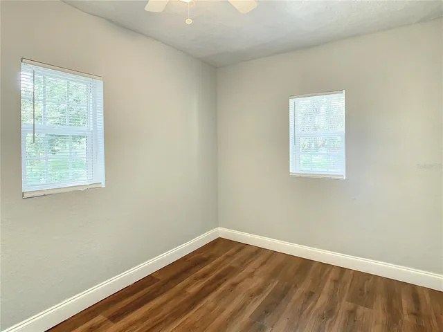 a view of a backyard with large trees