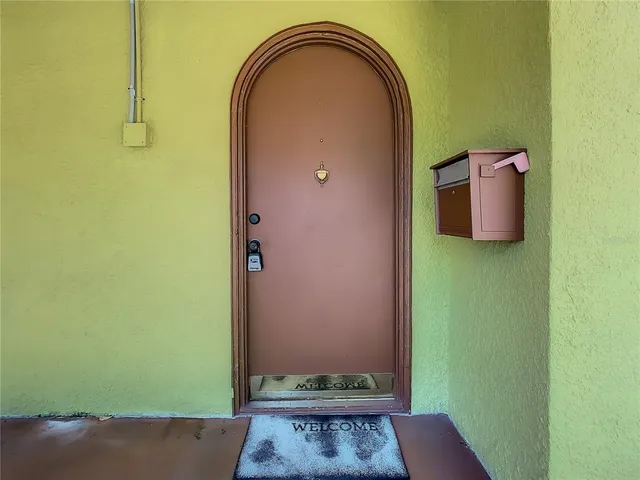 an aerial view of residential houses with outdoor space and trees all around