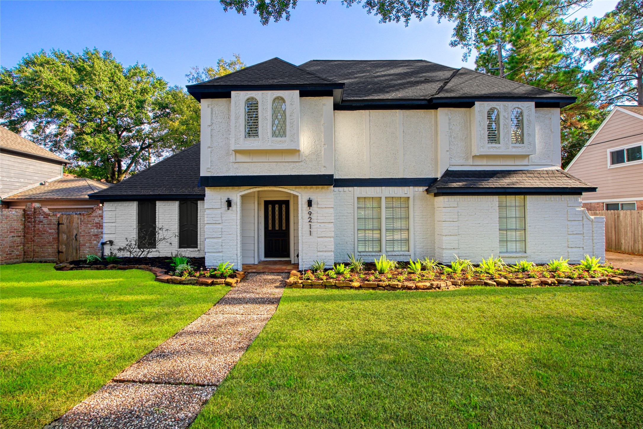 a front view of a house with a garden
