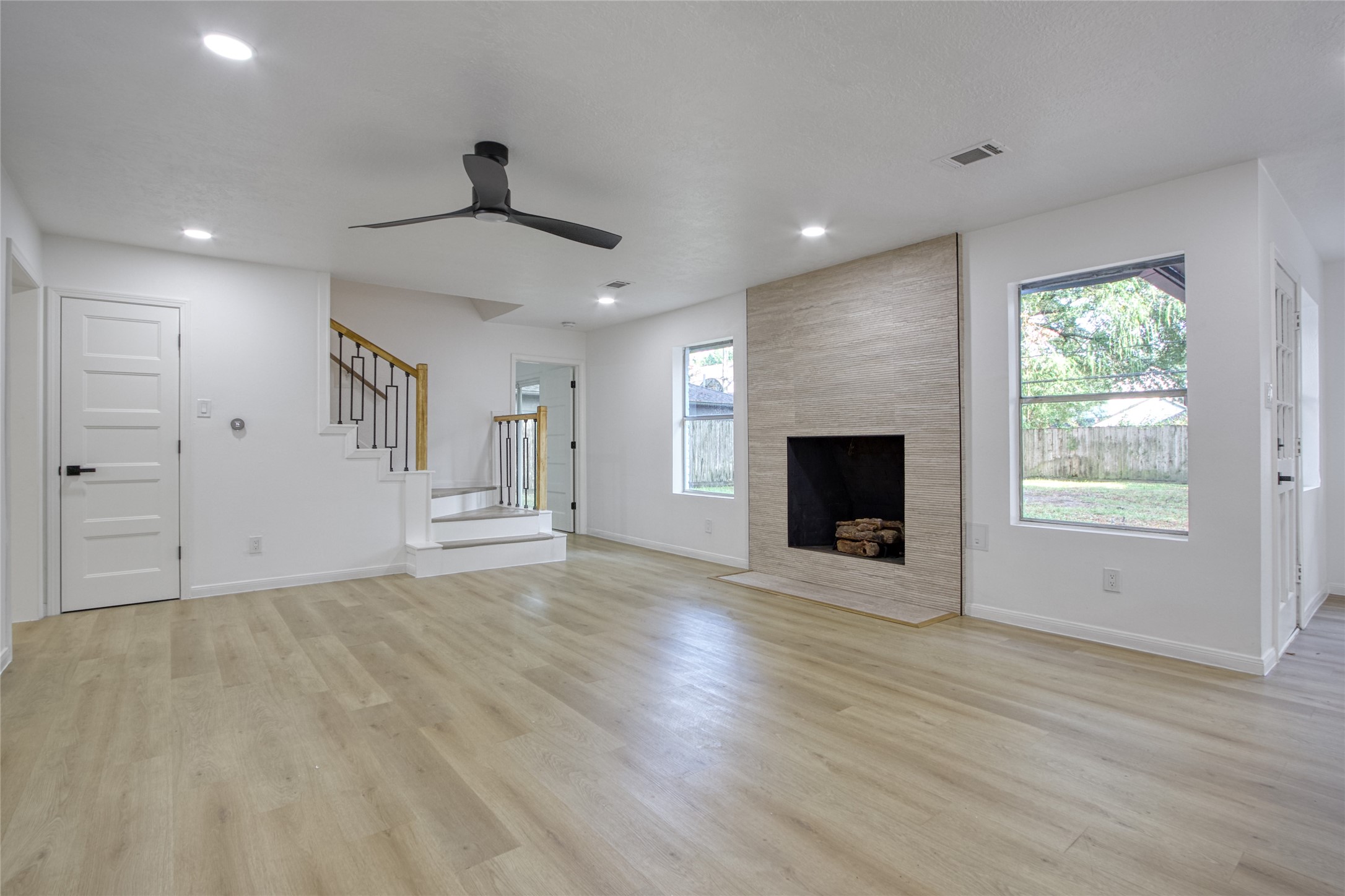 9211 Godstone Lane Spring, TX 77379 - Photo 12 of 30 a view of an empty room with a fireplace and a window