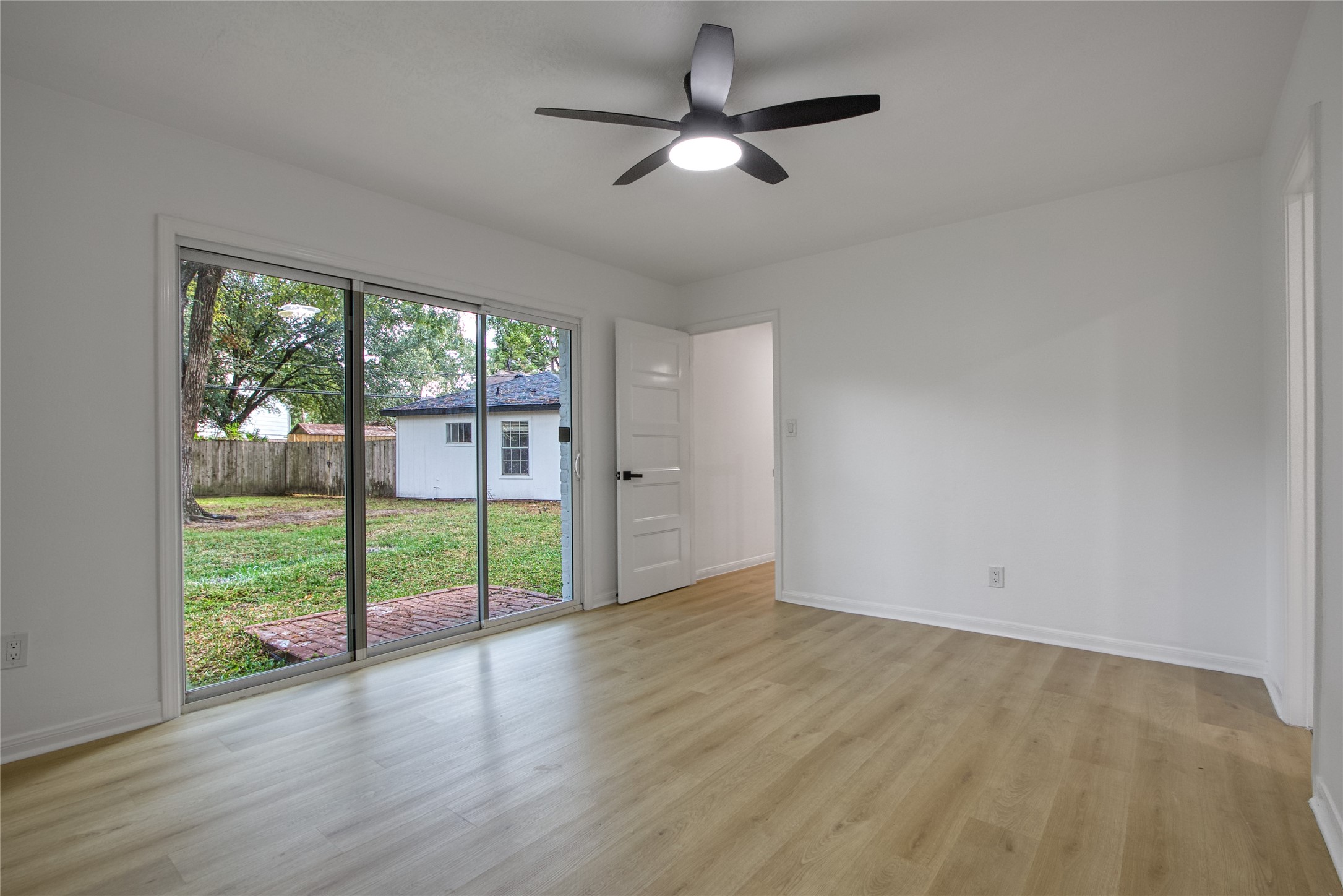 9211 Godstone Lane Spring, TX 77379 - Photo 17 of 30 a view of an empty room with wooden floor and a window
