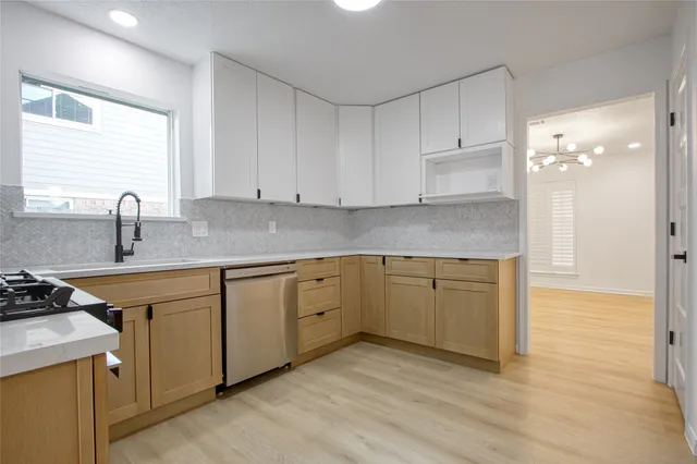 a kitchen with stainless steel appliances granite countertop a sink stove and cabinets