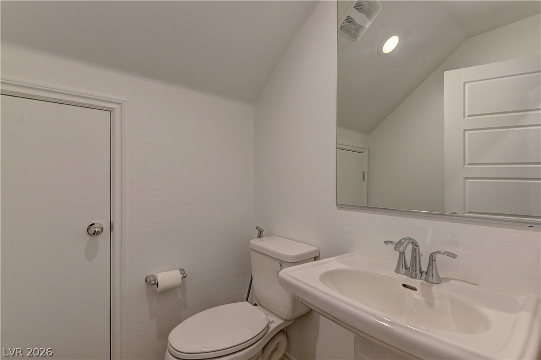 8827 Roadrunner Ravine Street Las Vegas, NV 89166 - Photo 11 of 17 Bathroom with toilet and vaulted ceiling