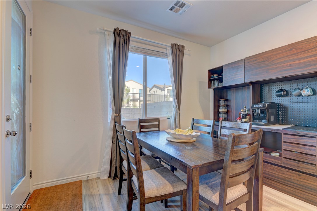 8827 Roadrunner Ravine Street Las Vegas, NV 89166 - Photo 12 of 17 Dining space with light wood-type flooring and baseboards