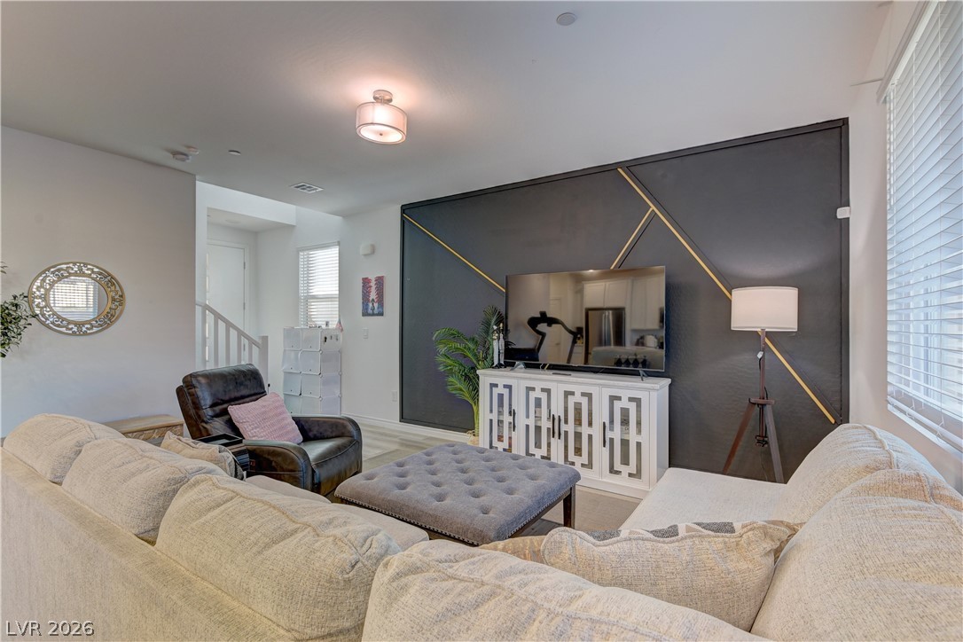 8827 Roadrunner Ravine Street Las Vegas, NV 89166 - Photo 15 of 17 Living area with wood finished floors and stairs
