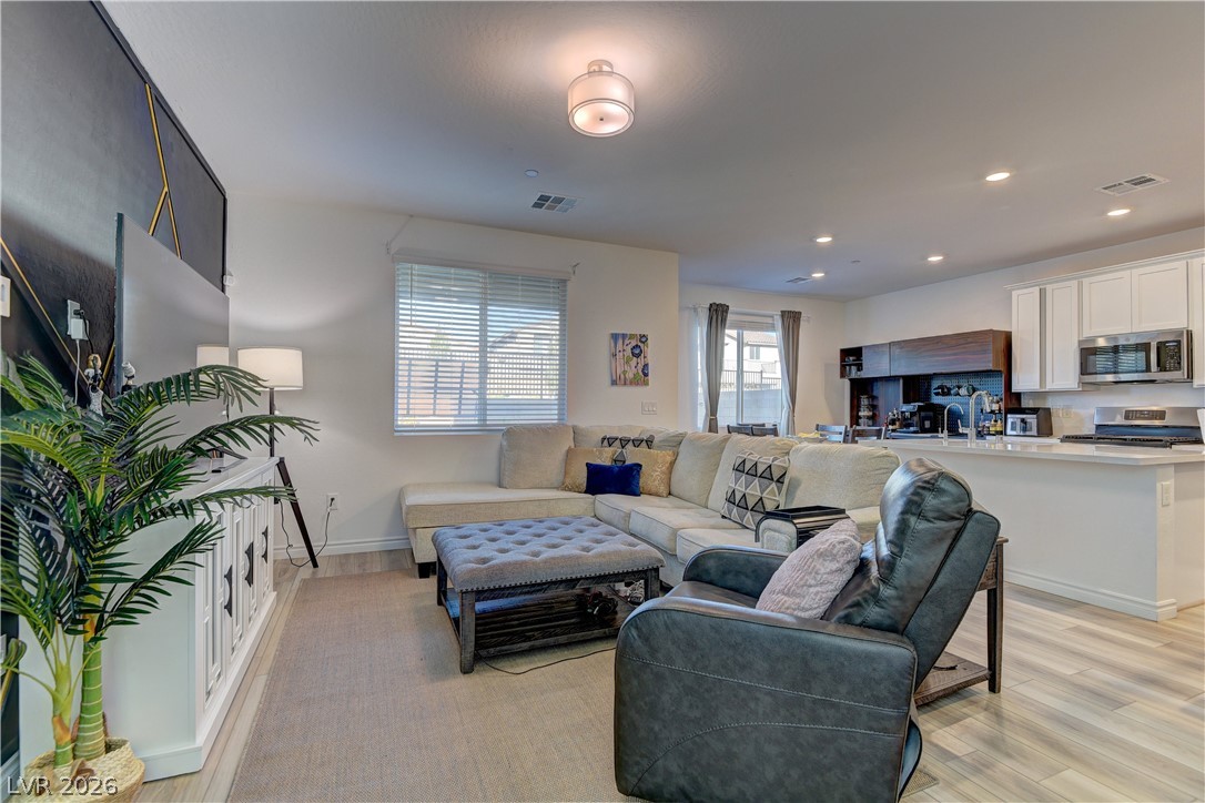 8827 Roadrunner Ravine Street Las Vegas, NV 89166 - Photo 16 of 17 Living area with light wood-style floors and recessed lighting