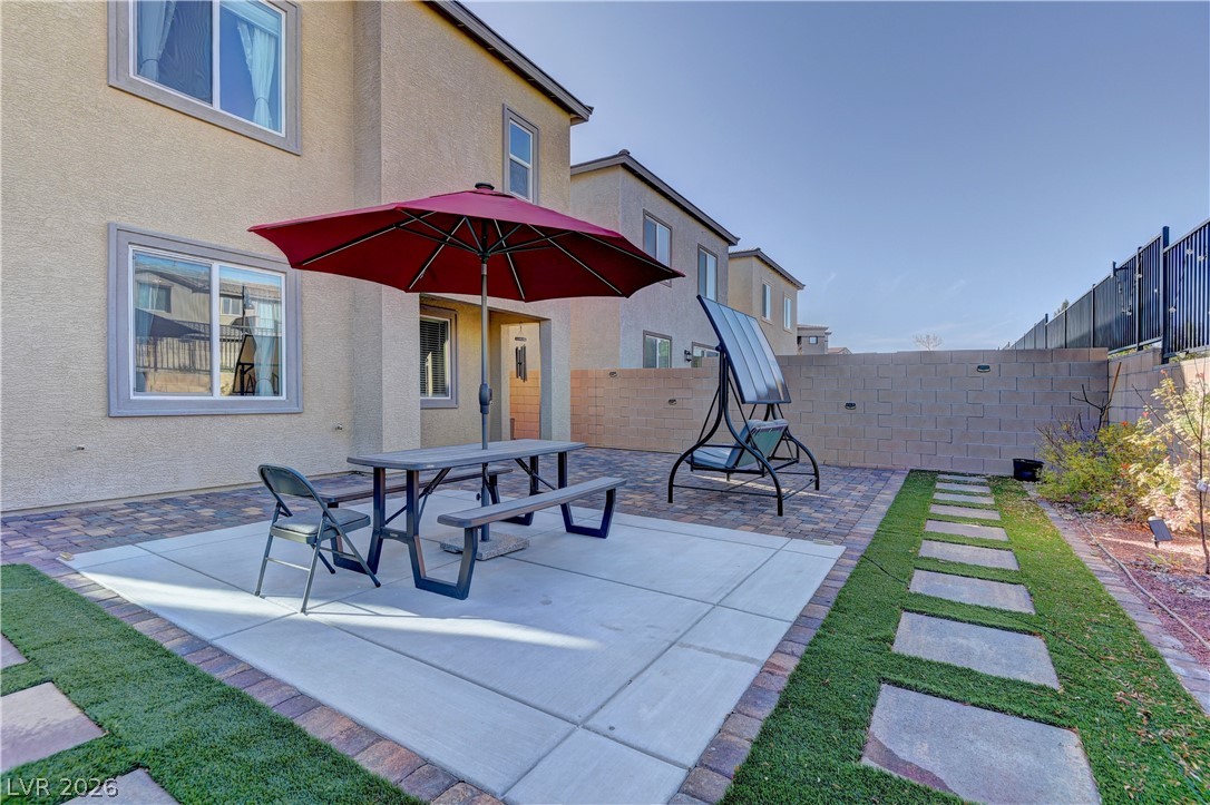 8827 Roadrunner Ravine Street Las Vegas, NV 89166 - Photo 2 of 17 Fenced backyard featuring a patio area and outdoor dining space