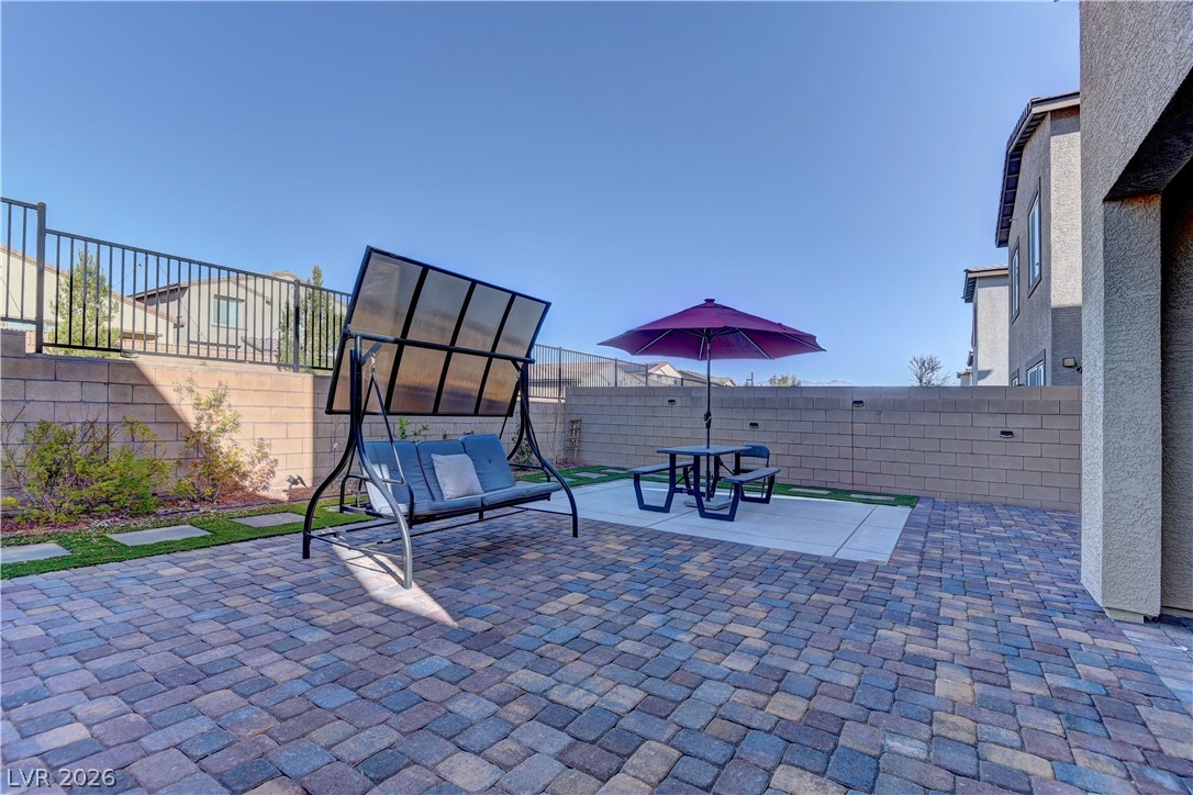 8827 Roadrunner Ravine Street Las Vegas, NV 89166 - Photo 4 of 17 Fenced backyard with a patio area and outdoor dining area