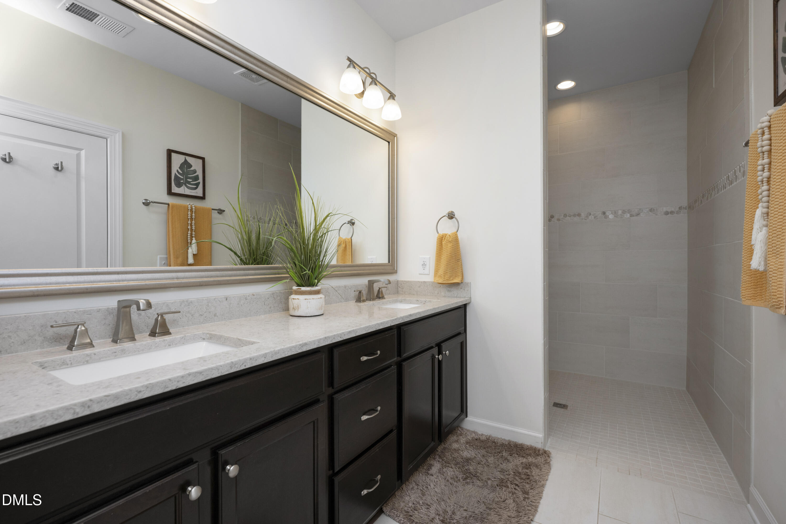 1345 Provision Place Wake Forest, NC 27587 - Photo 30 of 72 a bathroom with a double vanity sink and a mirror