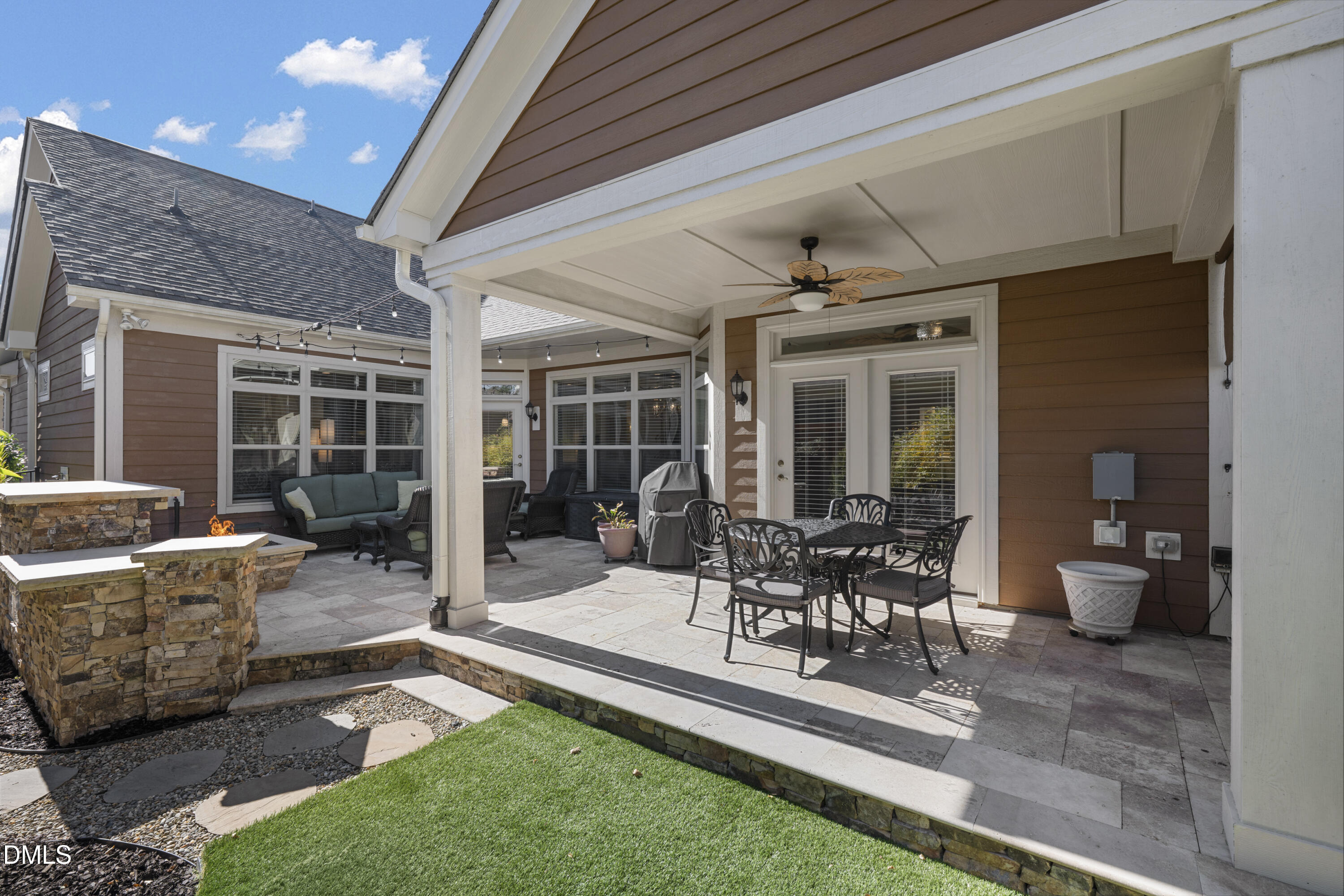 1345 Provision Place Wake Forest, NC 27587 - Photo 45 of 72 a view of a patio with table and chairs potted plants and floor to ceiling window