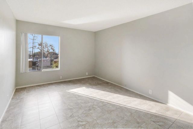 a view of kitchen with kitchen island and stainless steel appliances