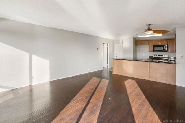 a view of a kitchen with wooden floor and a sink