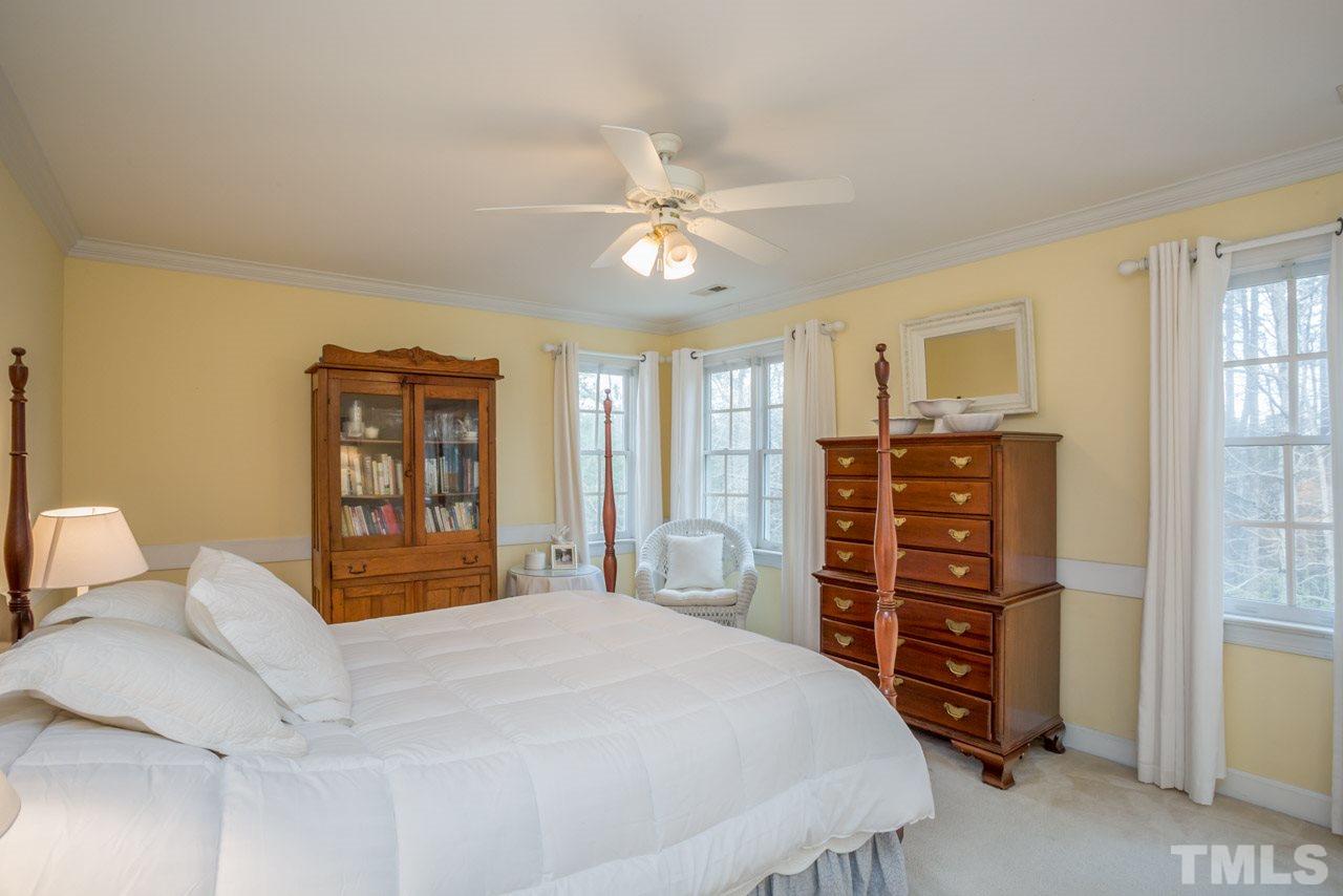2716 Dahlgreen Road Raleigh, NC 27615 - Photo 20 of 25 a bedroom with a bed a dresser and a large window