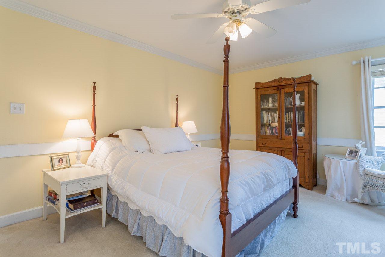 2716 Dahlgreen Road Raleigh, NC 27615 - Photo 21 of 25 a bedroom with a bed and a chandelier