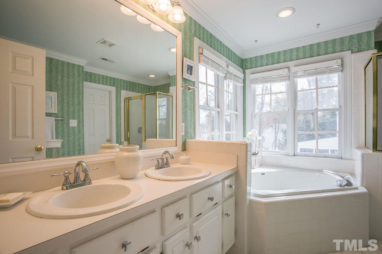 2716 Dahlgreen Road Raleigh, NC 27615 - Photo 22 of 25 a bathroom with a tub sink and mirror