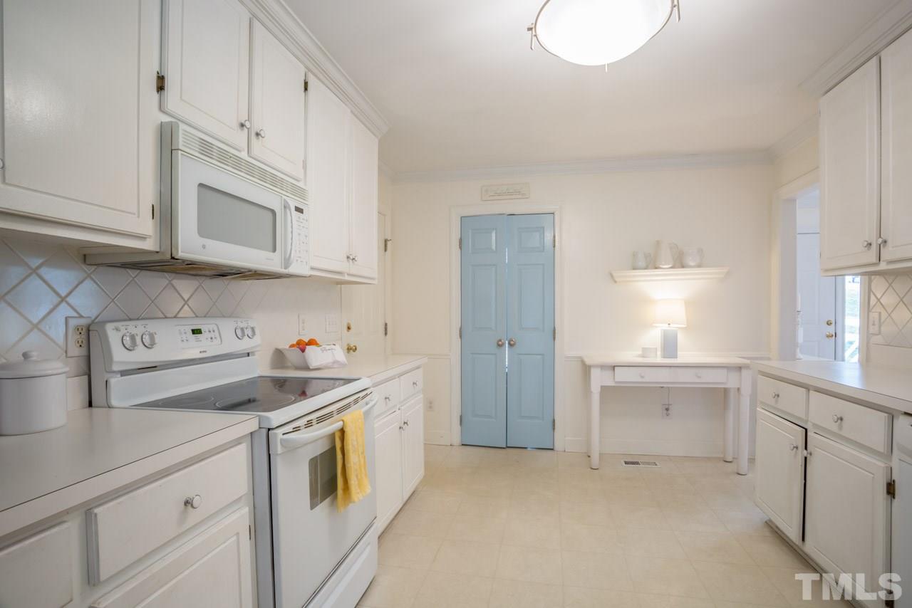 2716 Dahlgreen Road Raleigh, NC 27615 - Photo 9 of 25 a kitchen that has a lot of white cabinets