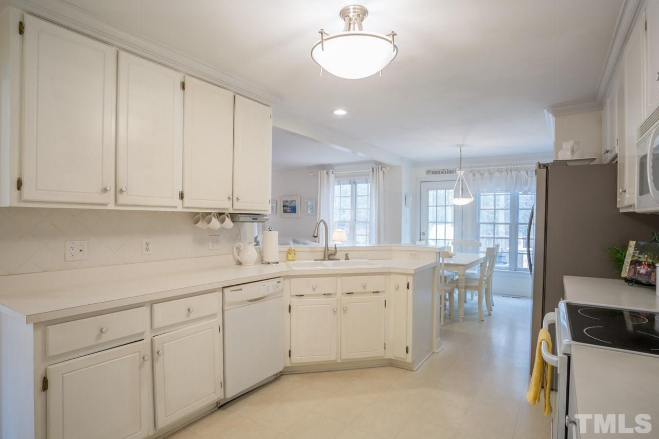 2716 Dahlgreen Road Raleigh, NC 27615 - Photo 10 of 25 a kitchen with white cabinets and sink