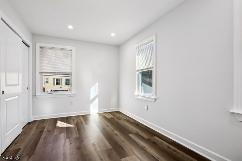85 Madison Street Newton, NJ 07860 - Photo 23 of 45 an empty room with wooden floor and windows