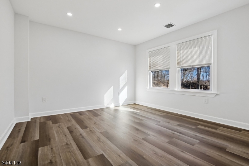 85 Madison Street Newton, NJ 07860 - Photo 28 of 45 a view of an empty room with wooden floor and a window