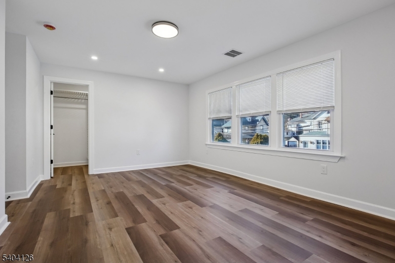 85 Madison Street Newton, NJ 07860 - Photo 30 of 45 a view of an empty room with wooden floor and a window