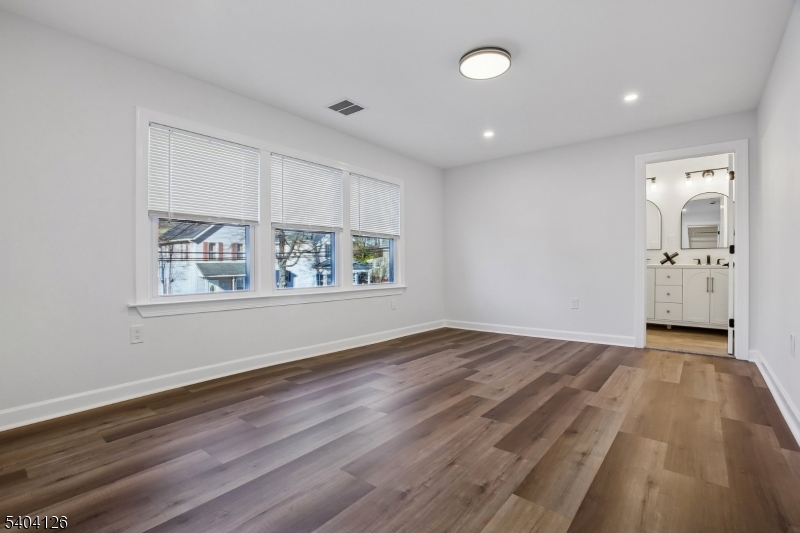 85 Madison Street Newton, NJ 07860 - Photo 31 of 45 an empty room with wooden floor and windows