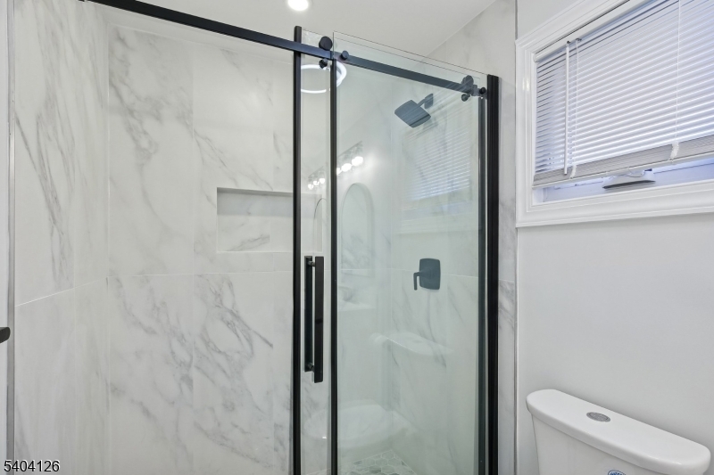 85 Madison Street Newton, NJ 07860 - Photo 33 of 45 a bathroom with a shower and a toilet