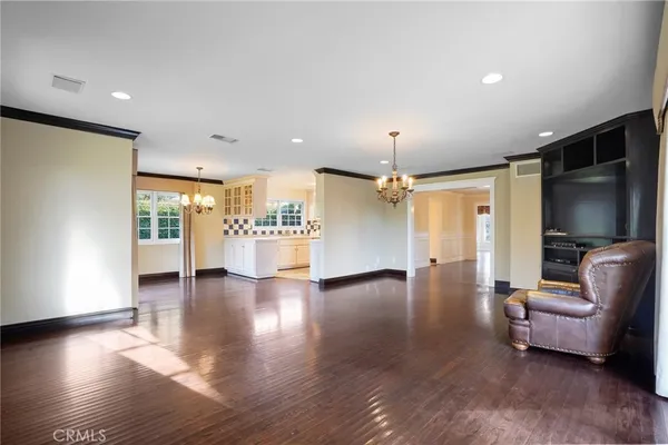 a view of a livingroom with furniture wooden floor and windows