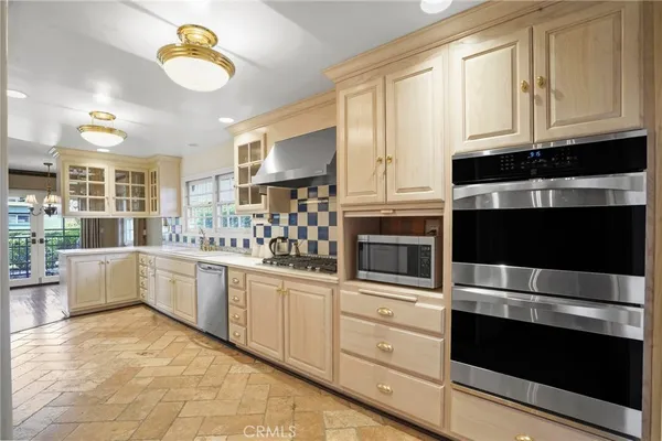 a kitchen with stainless steel appliances granite countertop a stove and a microwave