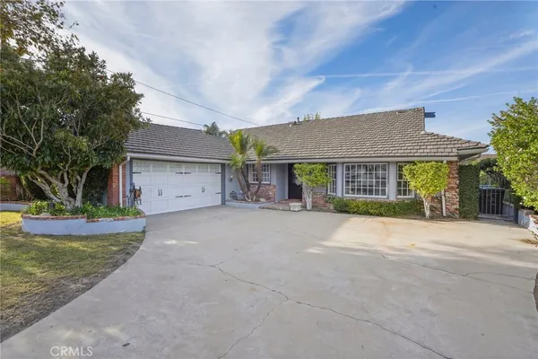 a view of a house with a yard and garage